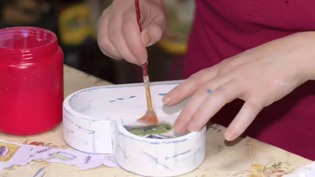 Hands applying decoupage