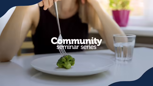 A person eating a pice of broccoli