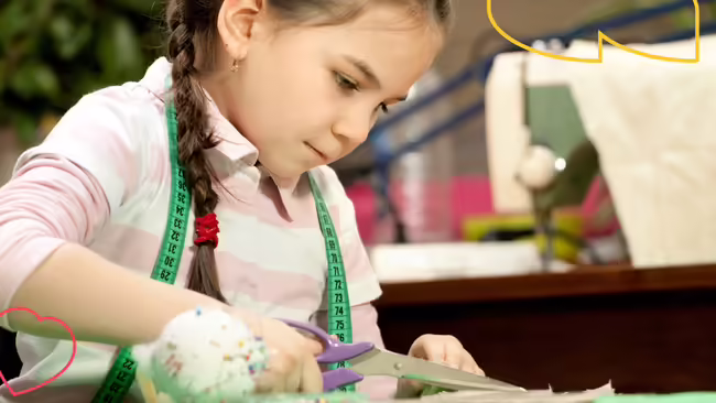 a little girl cutting fabric