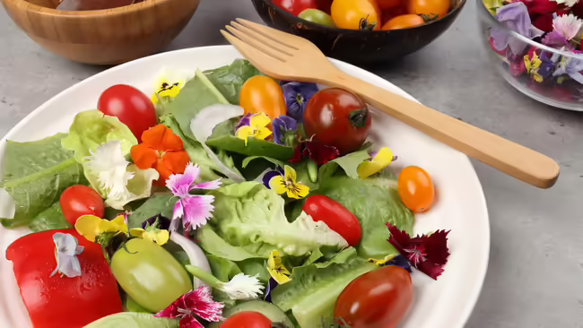 A salad made from vegetables and flowers from the garden 