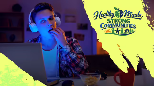 Person snacking at their desk with the words "Healthy Minds, Strong Communities"