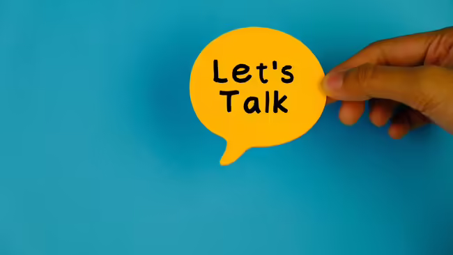 A yellow note with black and bold font that says "let's talk"
