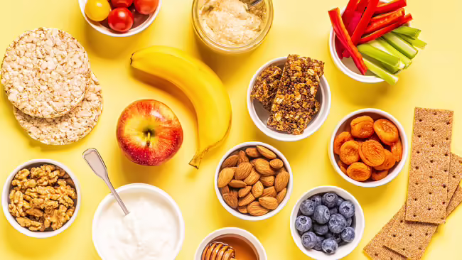 Various healthy snacks arranged on a yellow background.