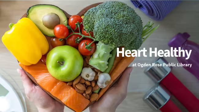 Heart shaped bowl with fruits and veggies surrounded by workout equipment