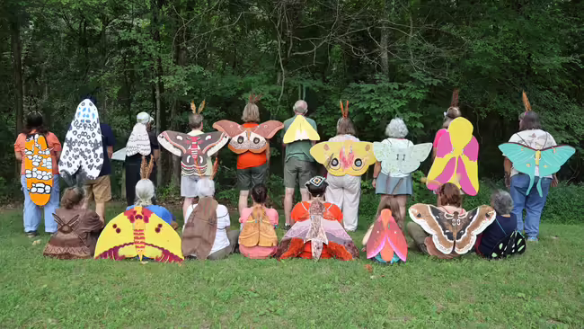 people wearing hand made moth wings