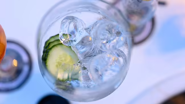cucumber slices in glass with ice