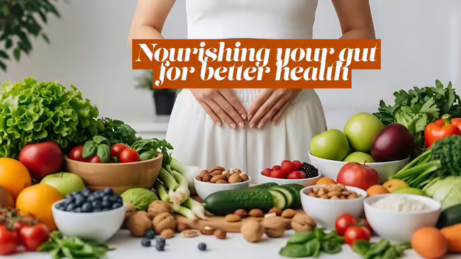 a table full of healthy foods and a woman behind it holding her stomach