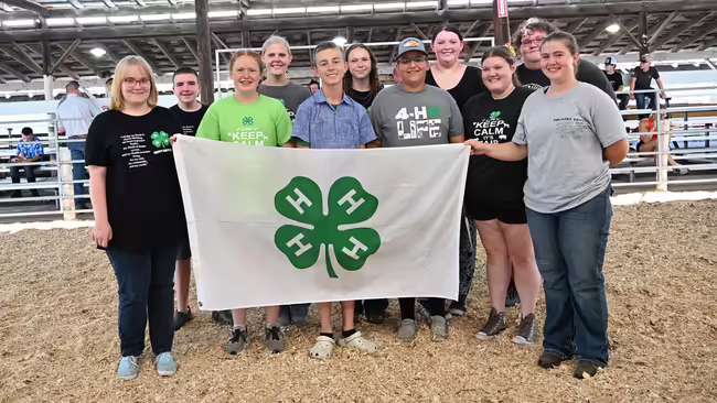 group of teens holding 4-H flag
