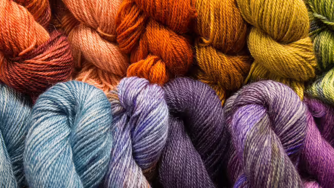 a close-up of yarn, bundled in a variety of colors