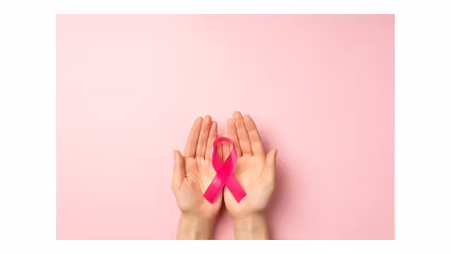 pink ribbon cupped in palms of two hands