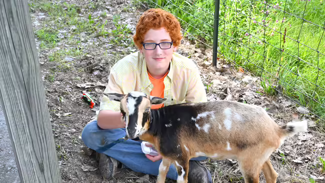 a boy with a goat