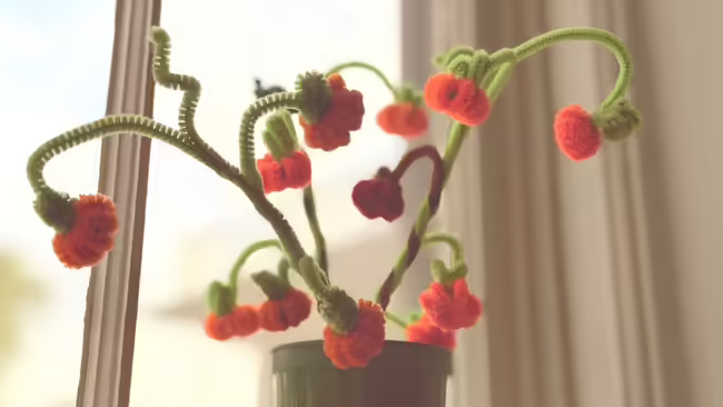 a pumpkin bouquet made out of orange and green pipe cleaners