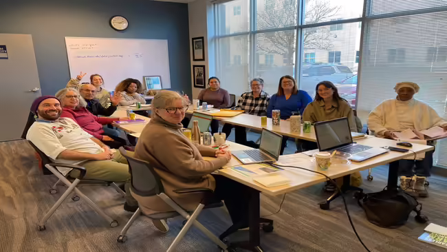 group of people sitting around open Square tables in office