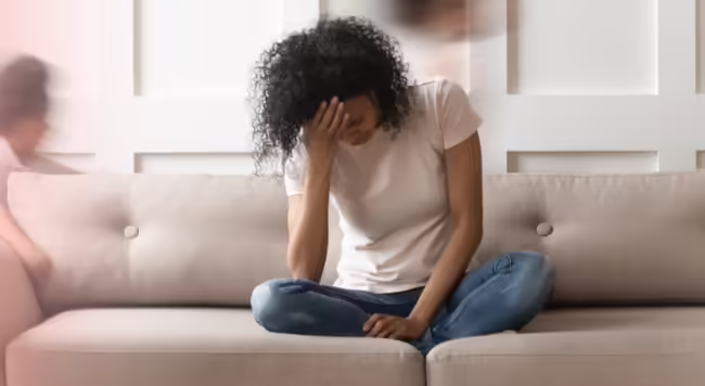teen sitting on a couch with head in her hands