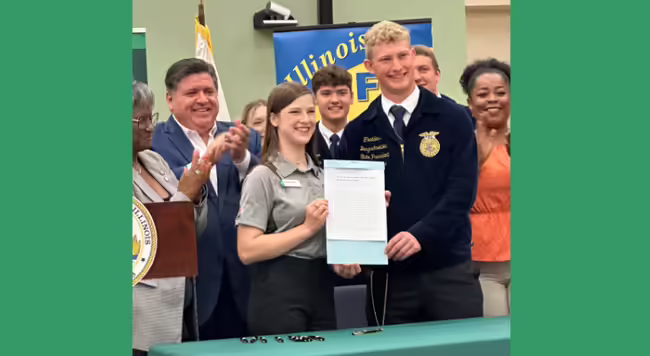 youth hold up the signed bill