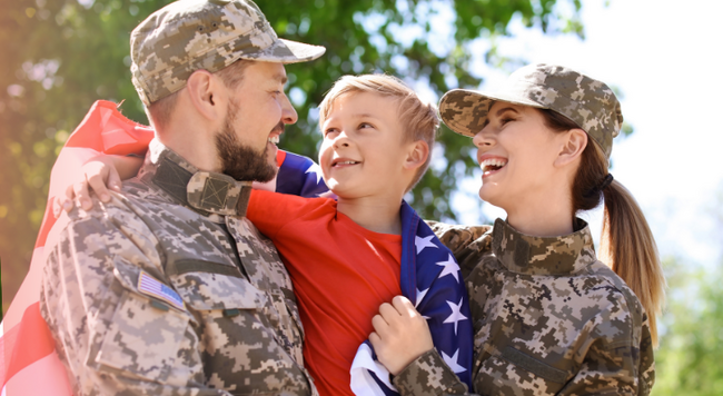 military family hugging with flag