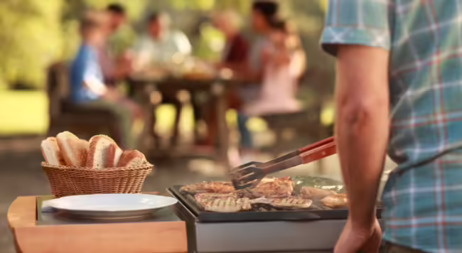 Man grilling burgers outdoors