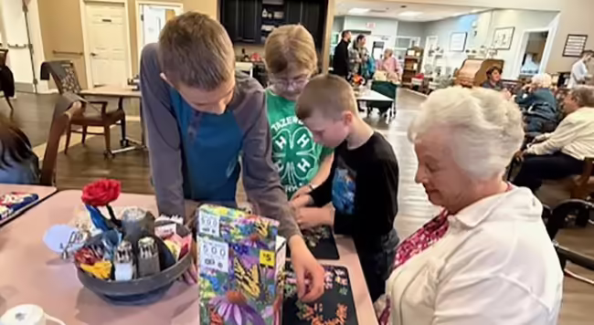 kids putting puzzle together with lady