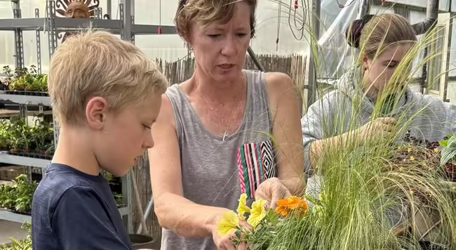 lady and boy planting flowers