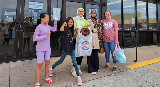 A group of young women with shopping bags
