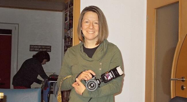 lady standing with camera resting in her arm