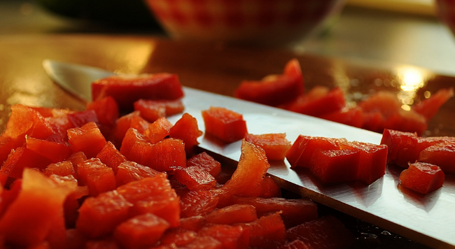 Chopped tomatoes surrounding a knife