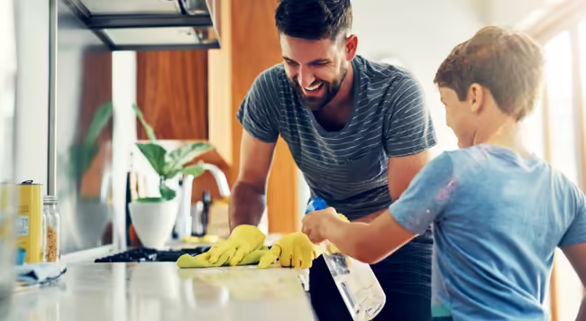 a father and son cleaning the kitchen