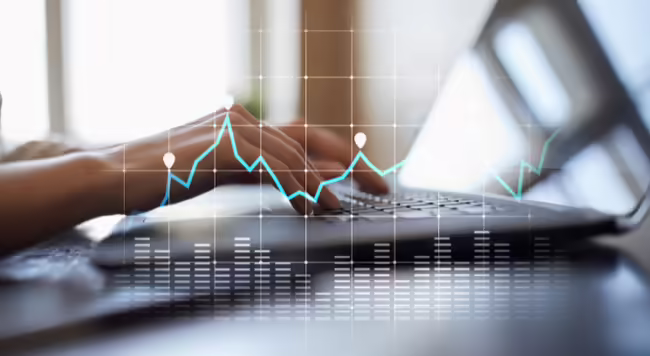 graph superimposed over hands on keyboard