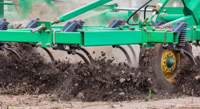 Tillage equipment moving through farm field
