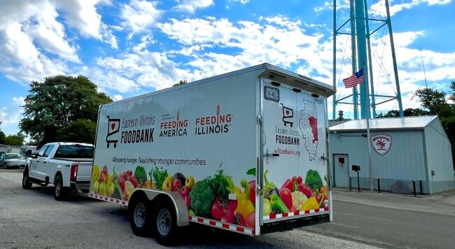 white truck pulling the Eastern Illinois Foodmobile trailer