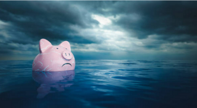 Piggy bank floating in ocean with cloudy weather 