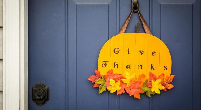 Give Thanks pumpkin decoration hanging on front door