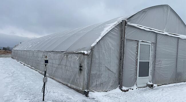 high tunnel in winter with snow on outside