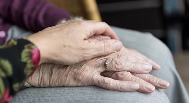 one younger hand on top of older hands