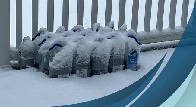recycled jugs and plastic bottles filled with soil and covered in snow
