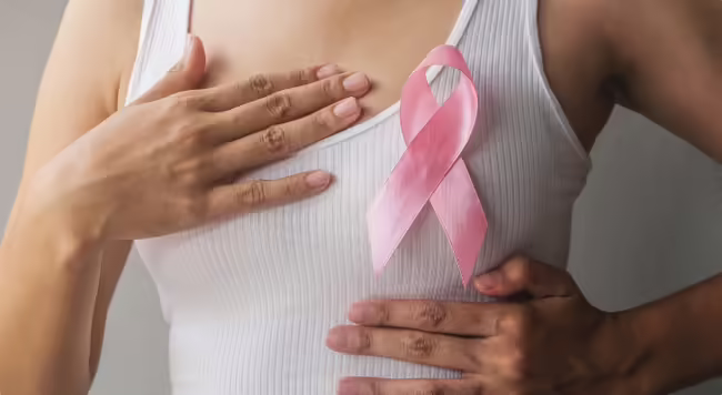 non identifiable woman wearing white tank and pink ribbon 