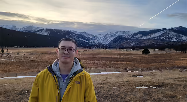 Steven Zhu with mountains
