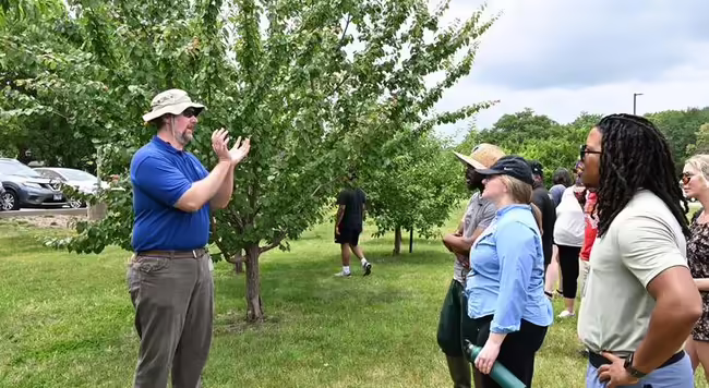 Dr Jon Fisher teaching in orchard