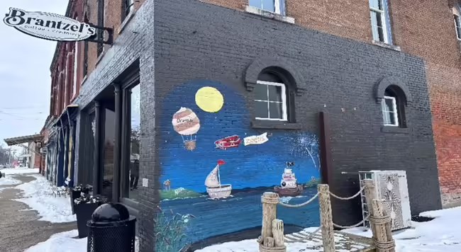 storefront on corner of block with mural on wall