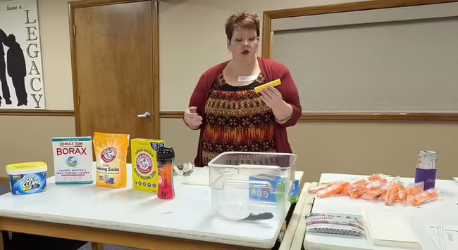 Woman speaking in front of a demonstration table