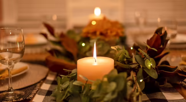 A lit candle on a table