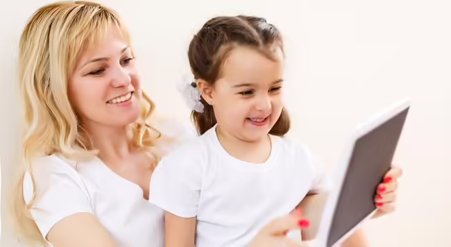 Mother and daughter looking at an electronic tablet