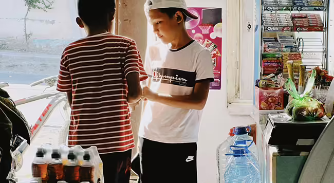 Two teen boys in a store
