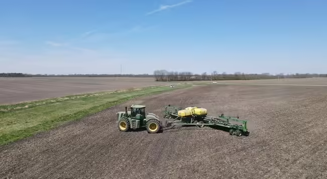 tractor pulling implement preparing the soil