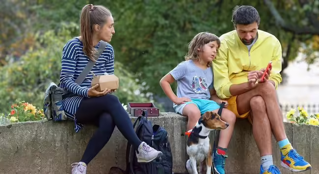 Parents with child looking at phone