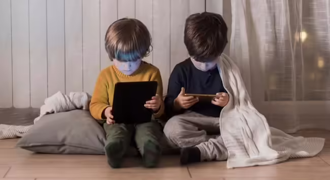 2 children on their tablets