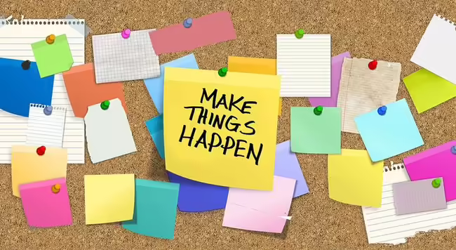bulletin board with notes pinned up and one note says Make Things Happen