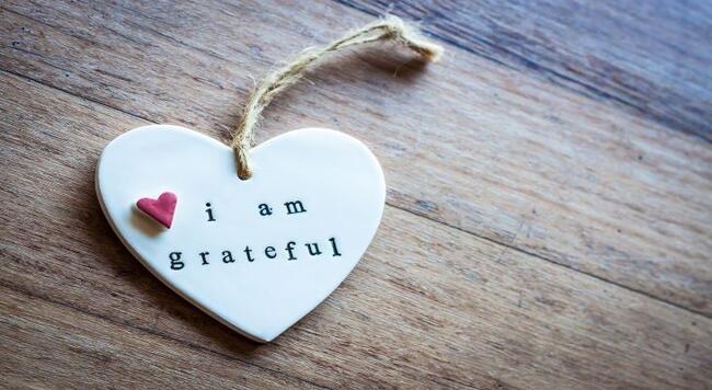 heart ornament with I am grateful printed on it