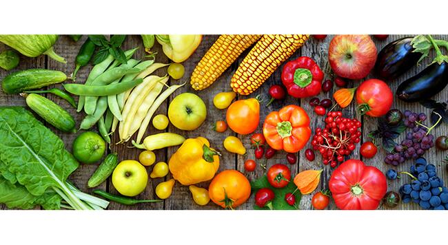 fresh fruits and vegetables arranged in rainbow order of color