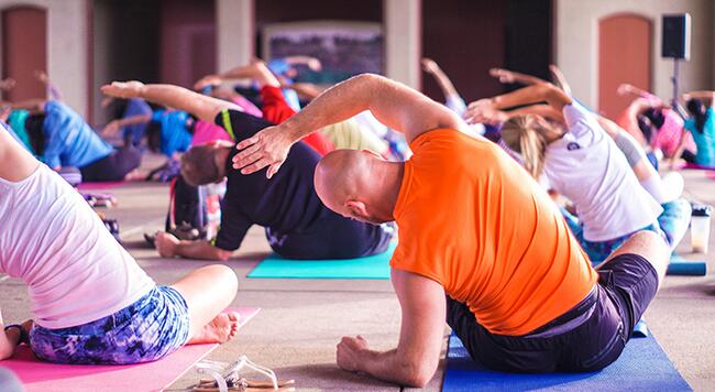 Group of people stretching and sitting on the floor